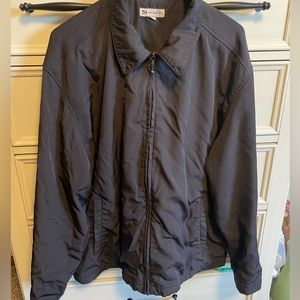 Black zip-up jacket, soft inside and windbreaker material outside
